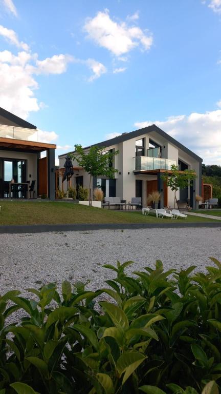 a house with a gravel driveway in front of it at Saos Terra Suites in Samothraki