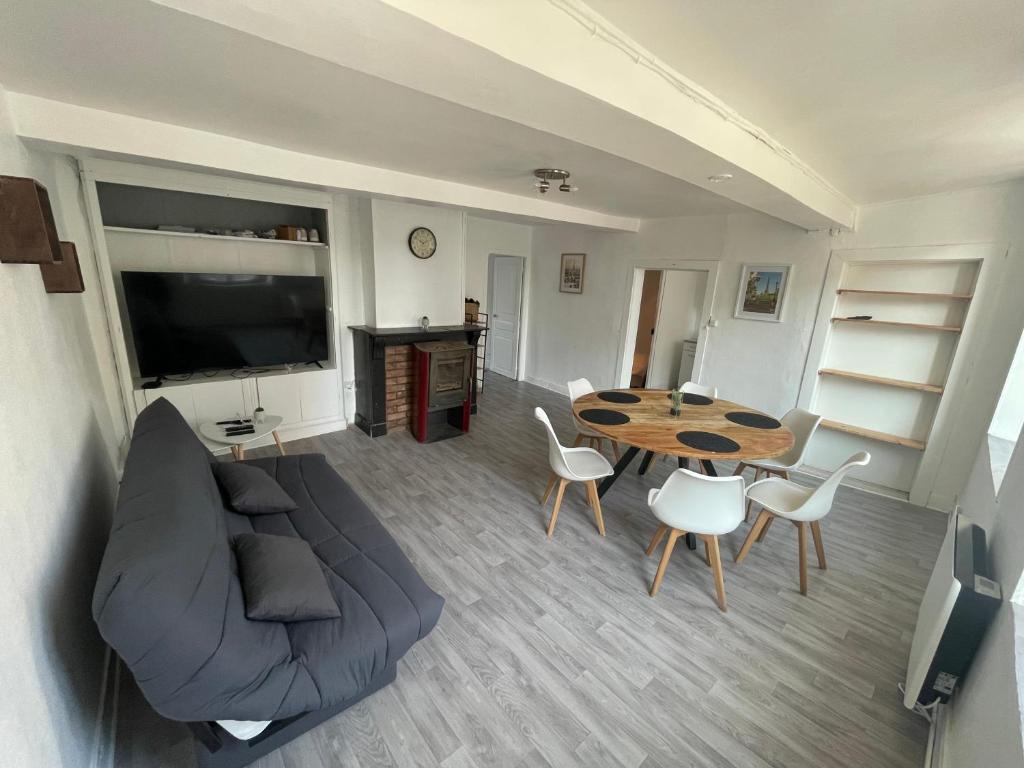 a living room with a couch and a table at Appartement 2 in Vireux-Wallerand