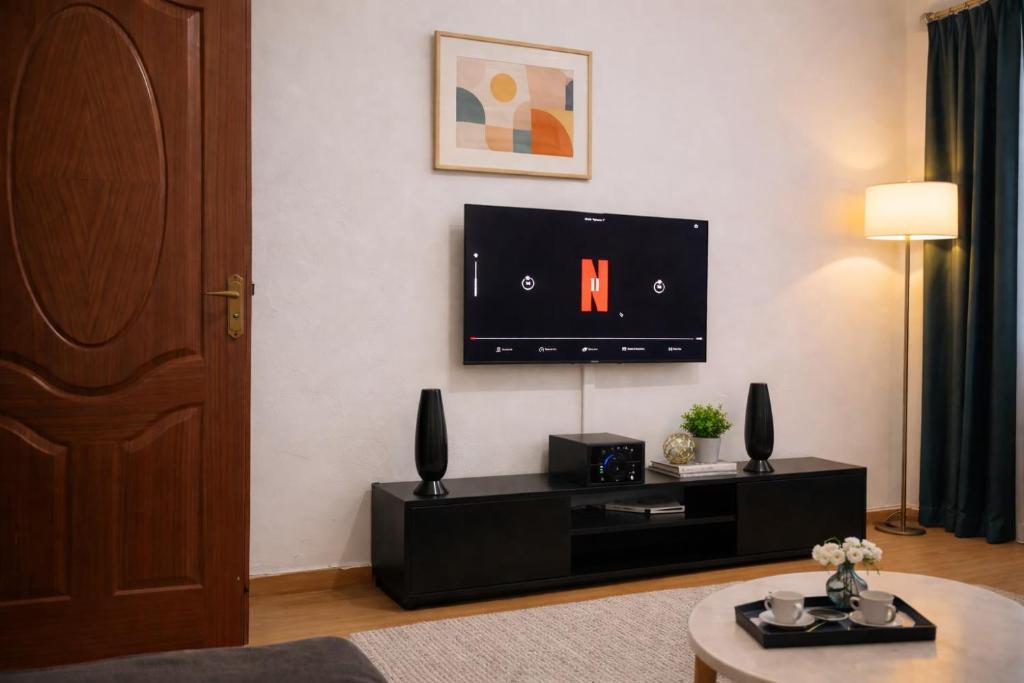 a living room with a flat screen tv on the wall at The Legend Place in Eldoret