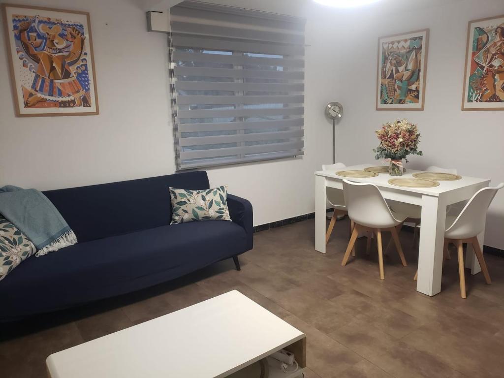 a living room with a couch and a table at Sálvora, Illas da Pousa in Ribeira
