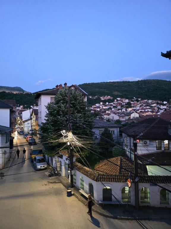 a person walking down a street in a town at Gashi Home in Prizren
