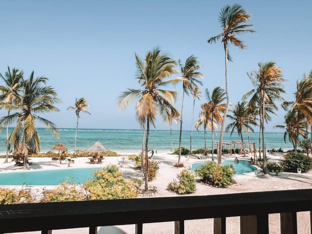 a view of the beach from the balcony of a resort at Villa Upendo with Private Pool and Ocean View Zanzibar in Pingwe