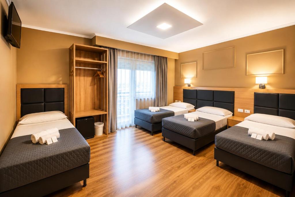 a room with two beds and two couches in it at EURHOTEL in Florence