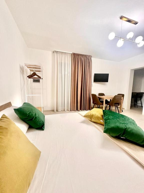 a living room with a bed with green pillows on it at A casa di Cetta in Melendugno