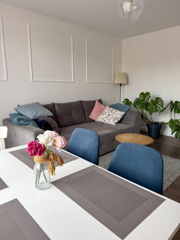 a living room with a couch and a table at Apartament Flauta in Mikołajki