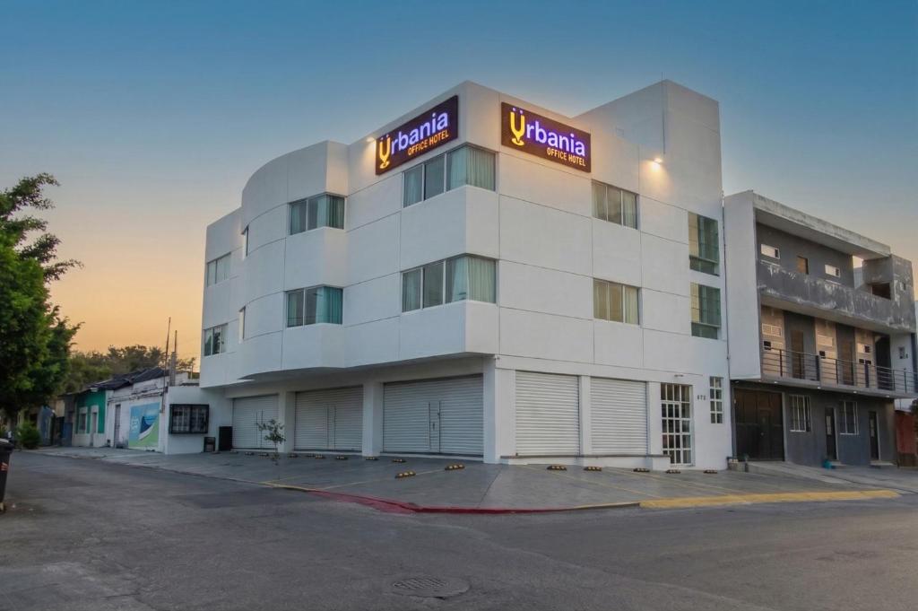 a large white building with a hotel sign on it at Urbania Office Hotel in Tuxtla Gutiérrez