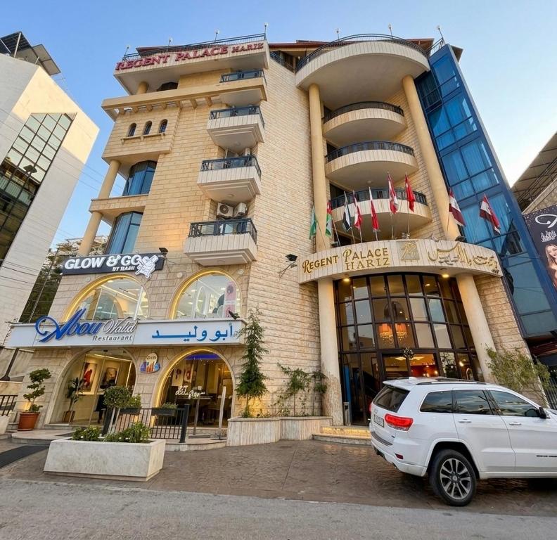 a white car parked in front of a building at Regent Palace Hariz Hotel in Aley