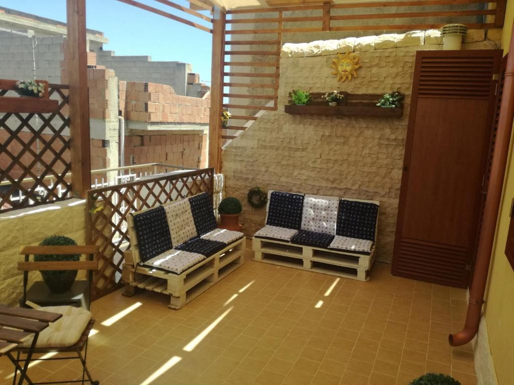 a balcony with two chairs and a table at Appartamenti la terrazza in Pachino