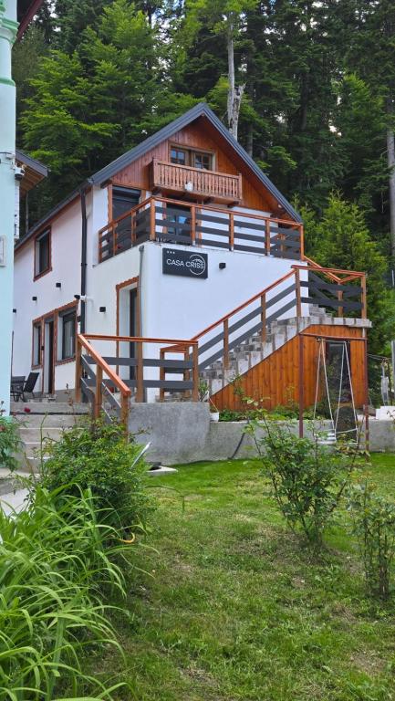 a large white house with a large balcony at Casa Criss in Sinaia