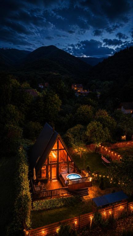 a cabin in the mountains at night with lights at Valdo Cabin in Sadu