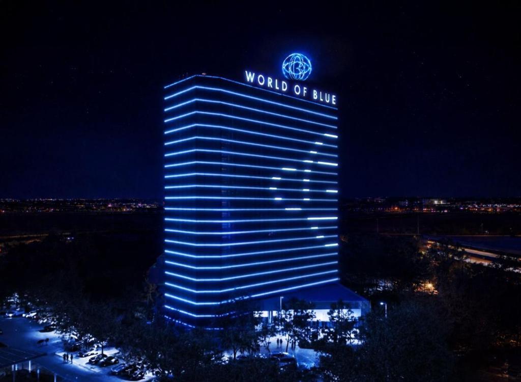a building with a sign on top of it at night at The World Of Blue in East Rutherford