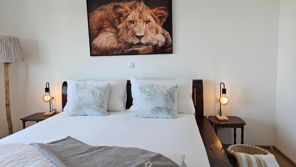 a bedroom with a bed with a lion picture on the wall at Feel Home Apartment in Dornbirn