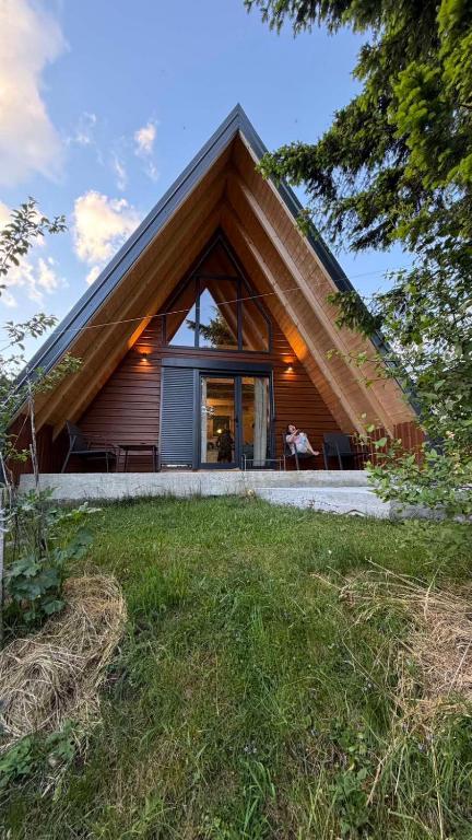 a house with a triangular roof with a window at Vila Mia in Žabljak