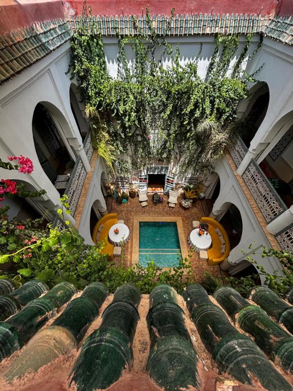 an overhead view of a building with a pool and plants at Riad Dar Al Assad in Marrakesh