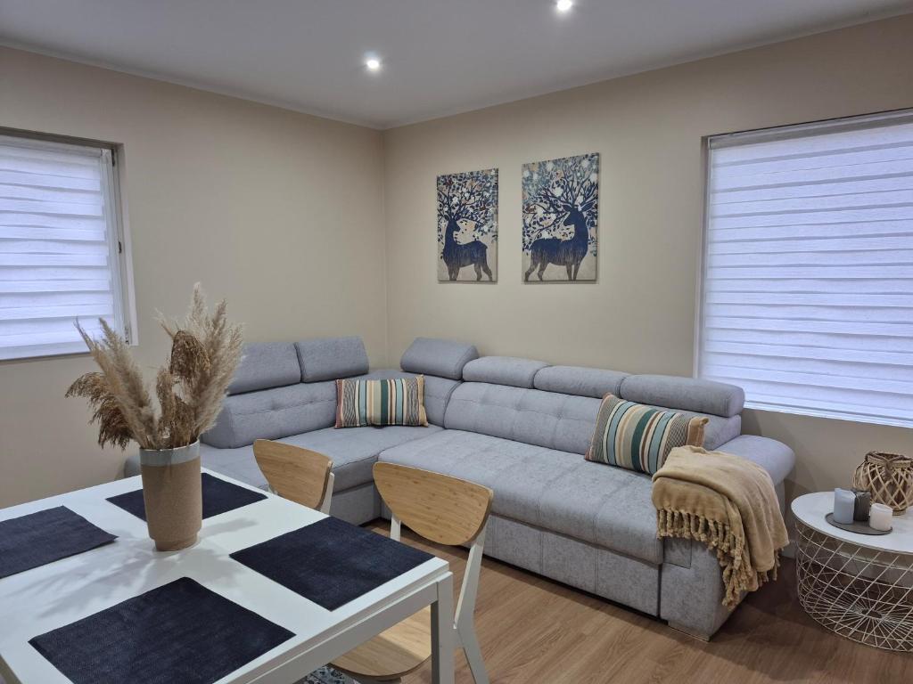 a living room with a couch and a table at Le Rond Point in Sieraków