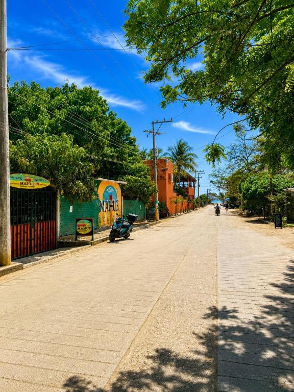 an empty street in a town on a sunny day at Casa Mahue in Puerto Escondido