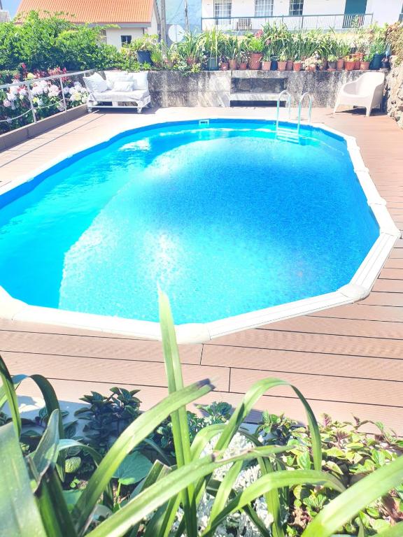a large swimming pool on a deck next to a house at Casa do Centro - Alojamento Local in Vieira do Minho