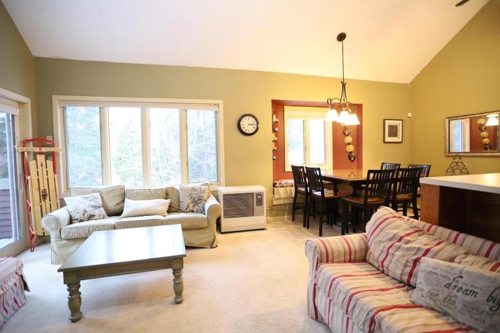 a living room with couches and a dining room at Forest Rim I1 WV Pet Friendly Ski Vacation Condo in Waterville Valley in Waterville Valley