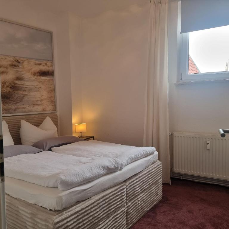 a bedroom with a bed with a painting on the wall at Apartment am Rathaus in Quedlinburg