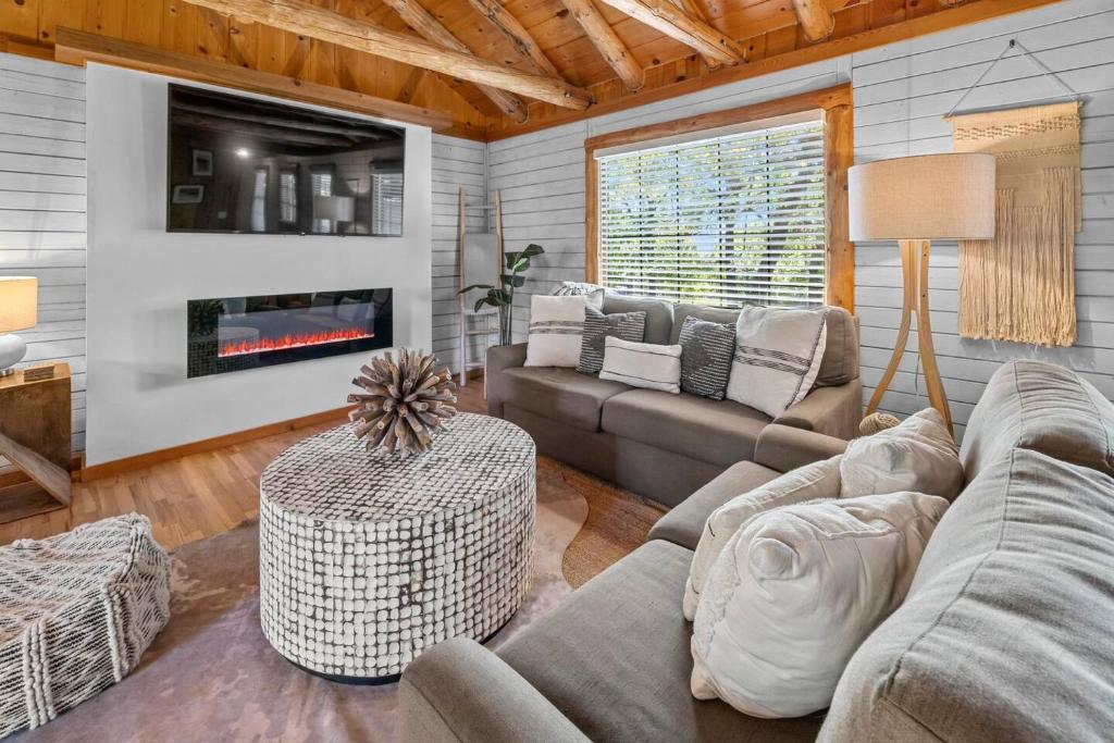 a living room with a couch and a fireplace at Serenity - 60 Ridge Lane in Branson