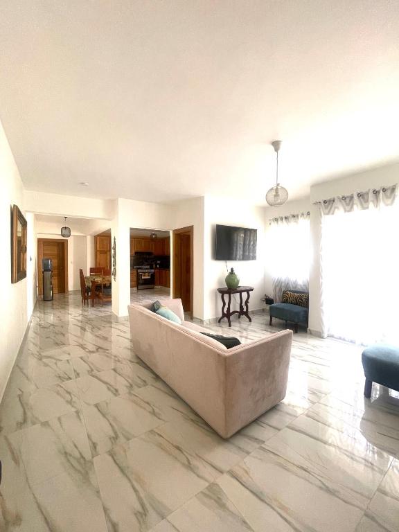 a living room with a large couch in the middle at Las Tres Casitas in San Felipe de Puerto Plata