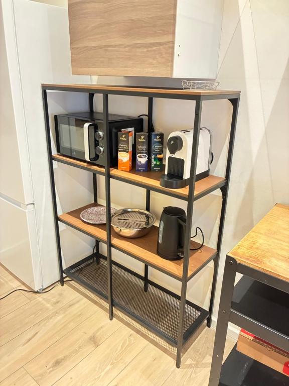 a shelf with a microwave and a toaster on it at Feinlötstube in Alzenau