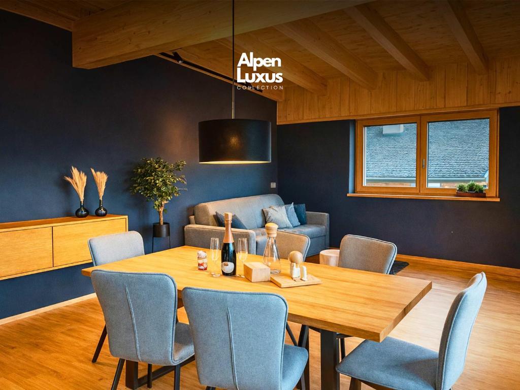 a dining room with a table and chairs and a couch at GLETSCHERBLICKSTUBE - Terrace & Mountain View in Fügen