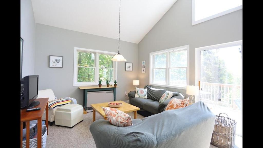 a living room with a couch and a table at Weetamoo Trail 50 Estates Relax in the White Mountains in Campton
