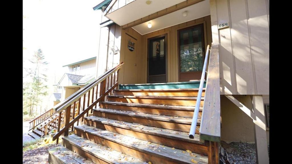 a set of stairs leading to a house with a door at Windsor Hill E53 WV Updated Pet Friendly Windsor Hill Condo in Waterville Valley