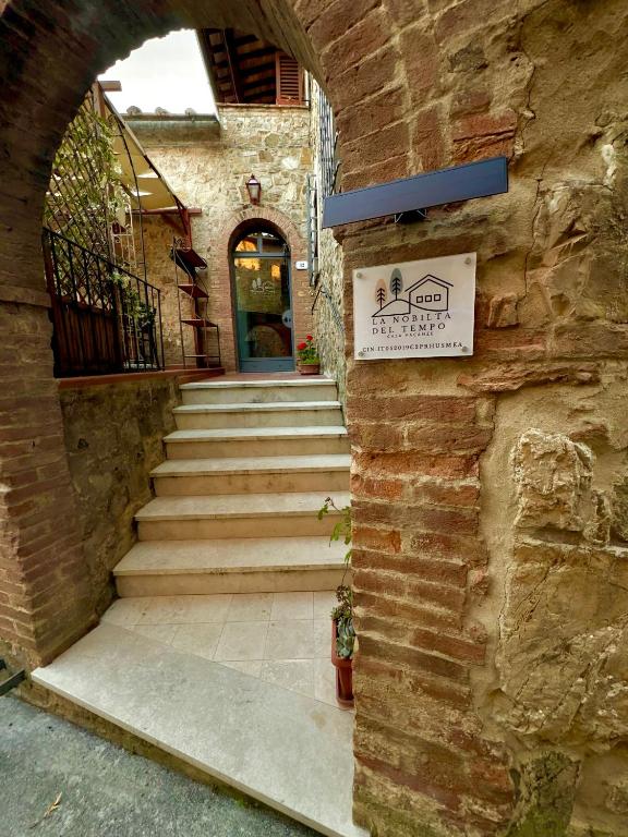 an entrance to a building with stairs and a sign at La Nobiltà del Tempo in Murlo