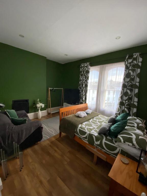 a bedroom with green walls and a bed at City Centre Double Room in Truro