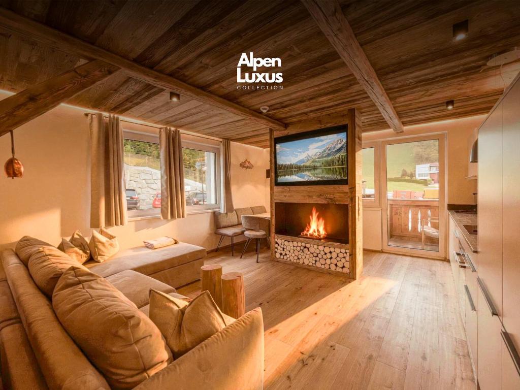 a living room with a couch and a fireplace at OLDWOOD CHALET - Design Chalet & Balcony in Fügen
