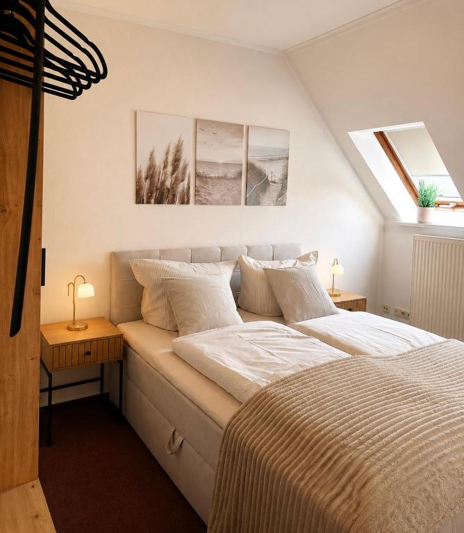 a bedroom with a bed with white sheets and pillows at Pension Glück in Schleife