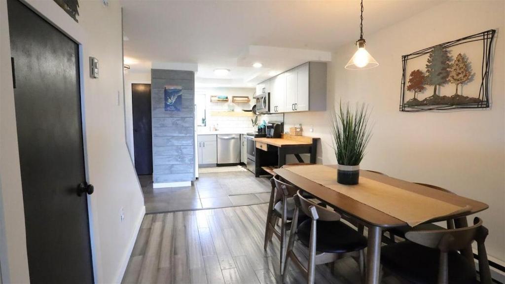 a kitchen and dining room with a wooden table in a room at Valley View 4 Campton White Mountain Condo With Views in Campton