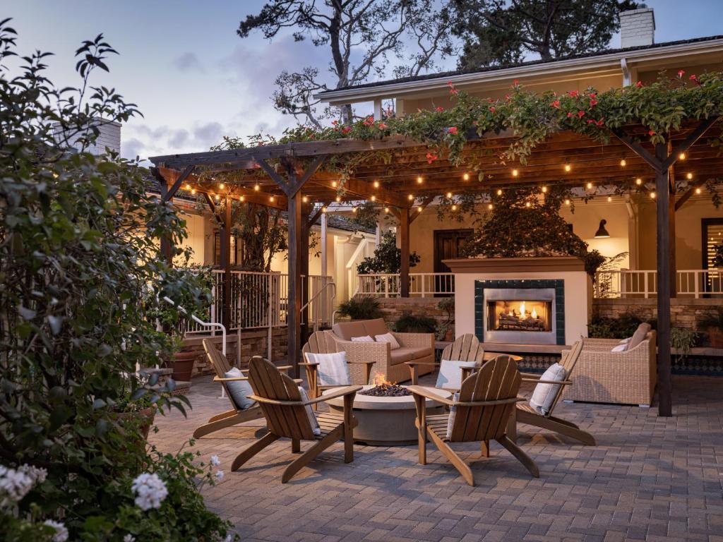a patio with a table and chairs and a fireplace at Hotel Carmel in Carmel