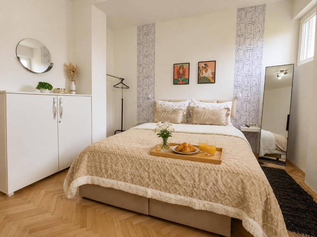 a bedroom with a bed with a tray of fruit on it at Green Paradise in Vrnjačka Banja