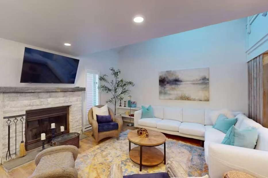 a living room with a couch and a fireplace at 103 Ruffed Grouse Ct in Lake Harmony