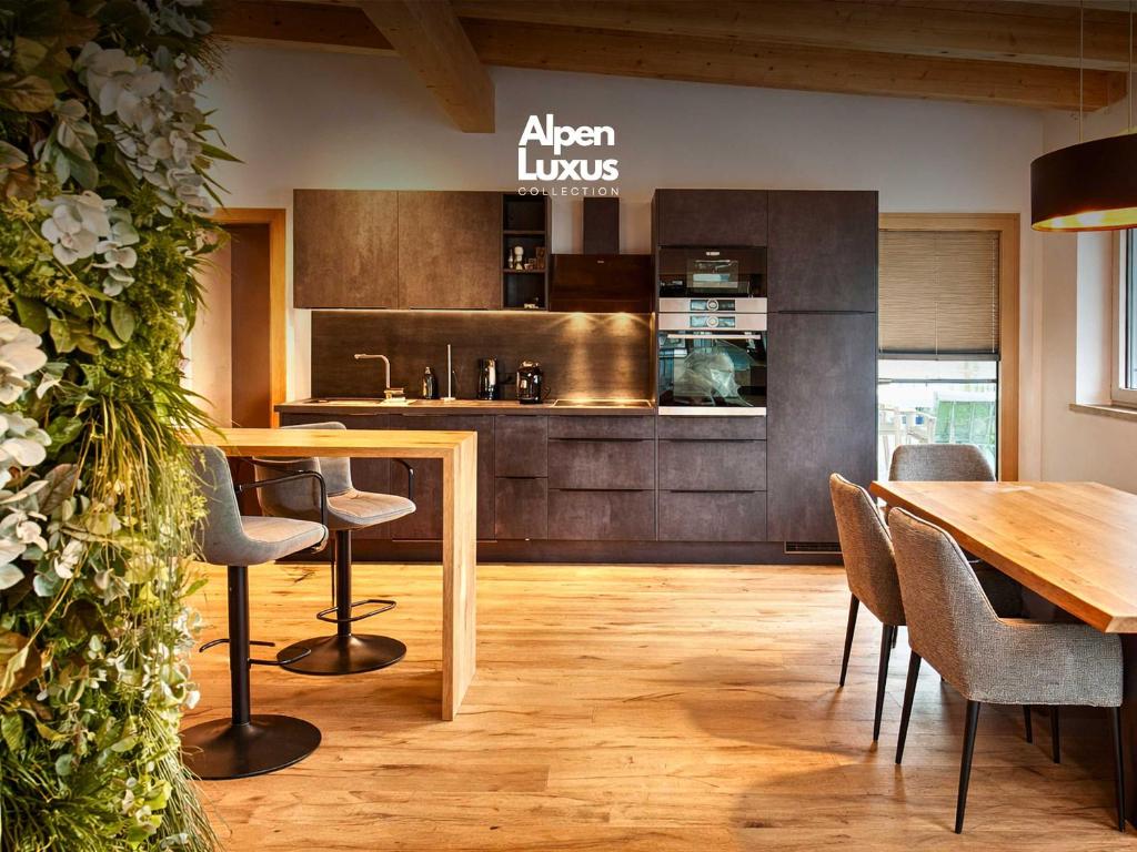 a kitchen and dining room with a table and chairs at ViVaZILARE - Design Loft with Terrace in Fügen