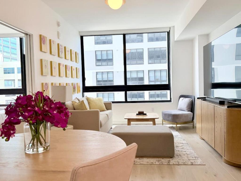 a living room with a table with flowers on it at Chic Luxury 1BR Oasis in Miami