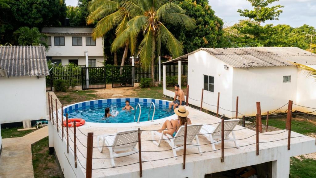 a group of people in a swimming pool at Cabaña Los Cristales Coveñas by Amauna in Coveñas