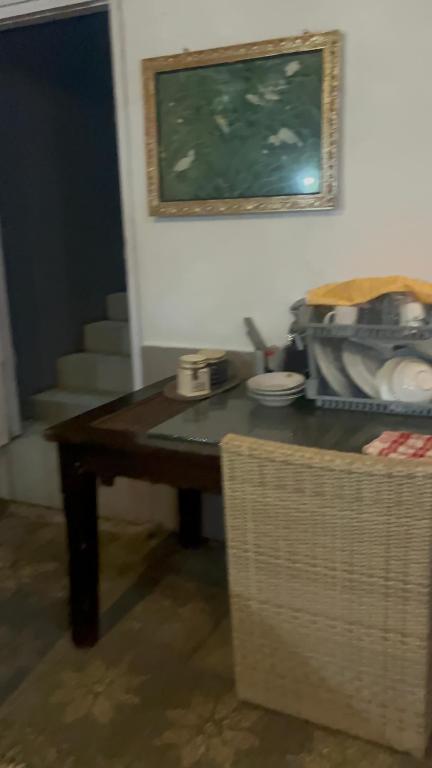 a table in a room with a picture on the wall at D,lacoco in Kubupenlokan