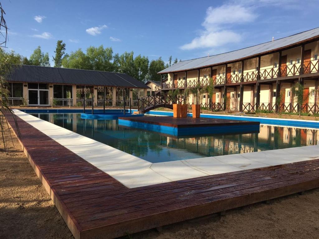 a swimming pool in front of a building at La Delfina Island Resort in Tigre