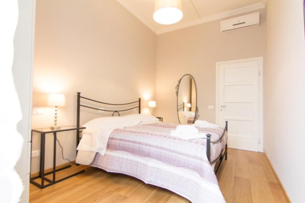 a bedroom with a bed and a mirror at Cittadella 5 in Florence