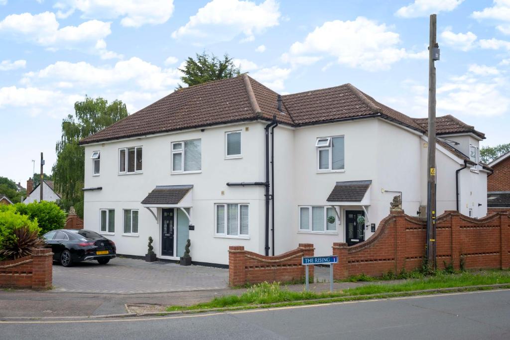 a white house with a brown roof at Sunnymede Court in Billericay