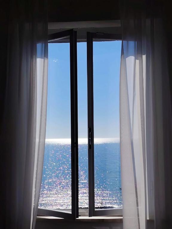 a window with a view of the ocean at Castello Di Marà in Cupra Marittima
