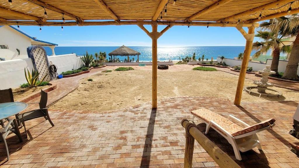 a patio with a table and chairs and the beach at Casa Evita in Puerto Peñasco