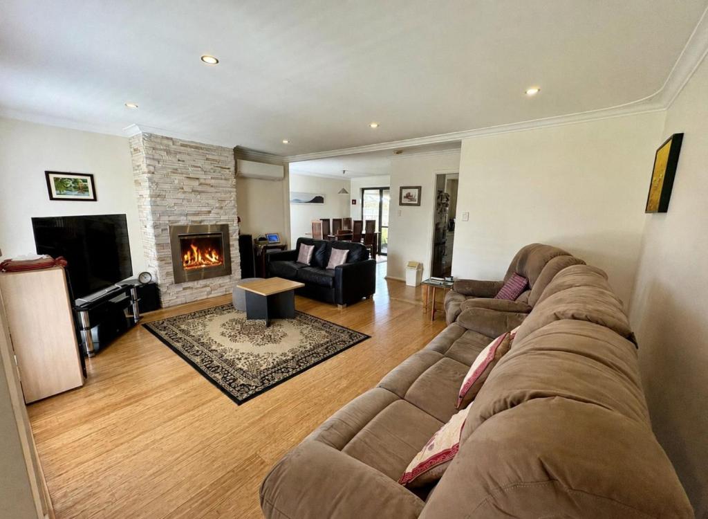 a living room with a couch and a fireplace at Beachside Escape - Broadwater in Broadwater