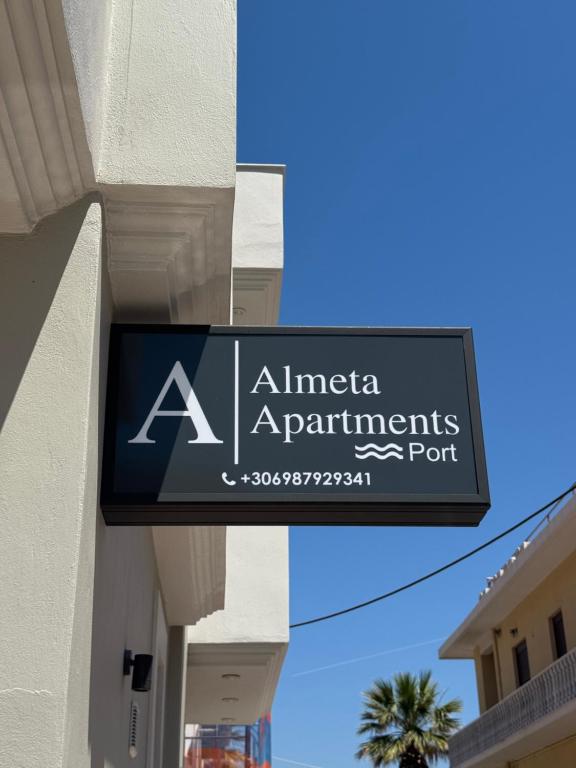a sign on the side of a building at Almeta Apartments Port in Chios