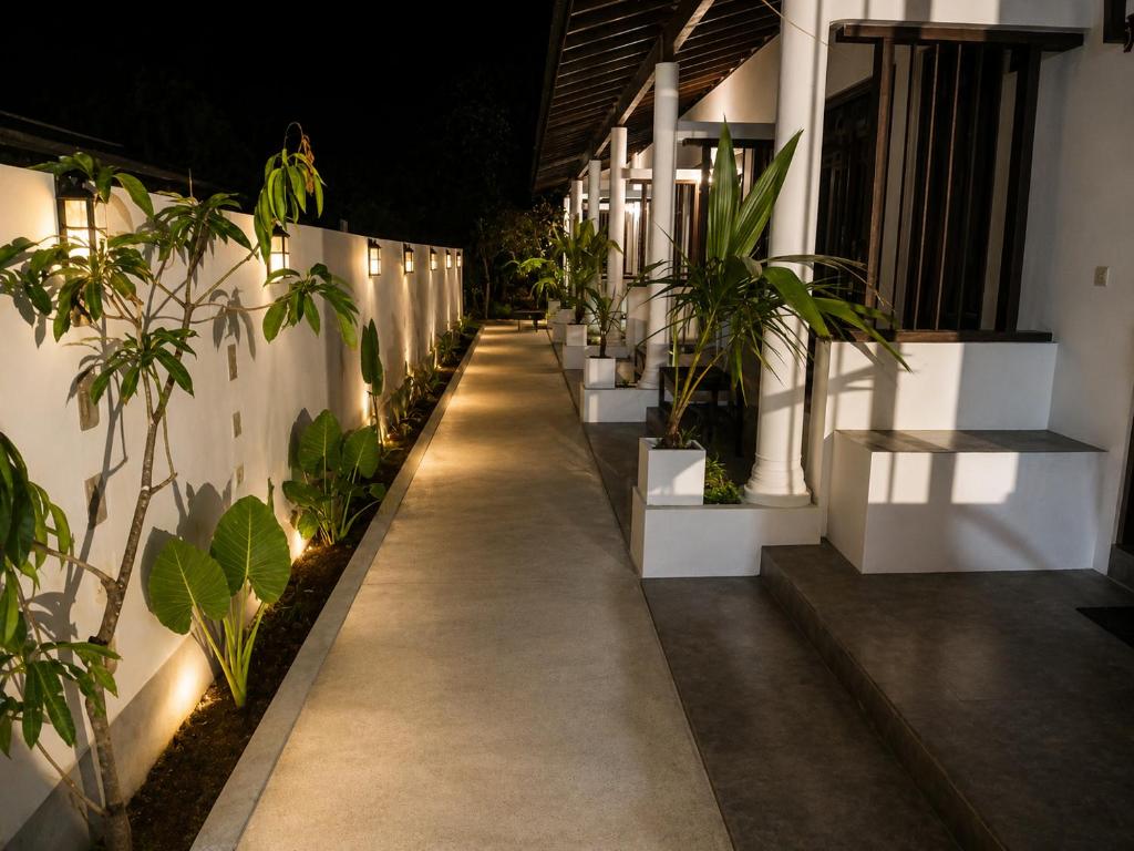 a walkway with potted plants on the side of a building at Kentz villa in Arugam Bay
