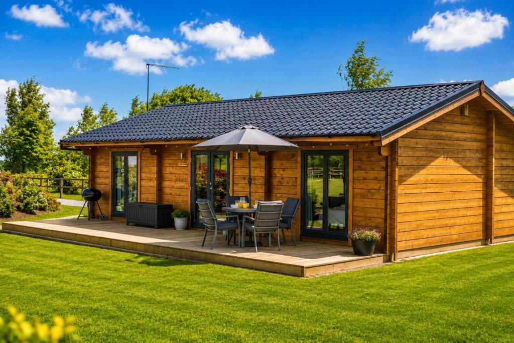 a wooden cabin with a table and chairs on a deck at 2 Bed in Nafferton oc-p31955 in Nafferton